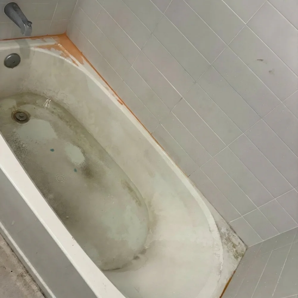 Bathtub before cleaning — heavy grime and stains
