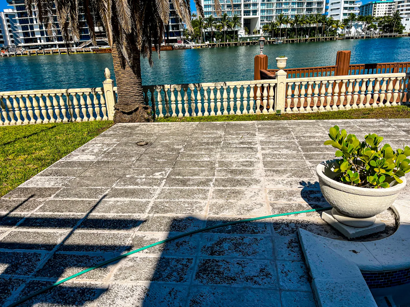 Stone terrace mid pressure washing with a visible clean line