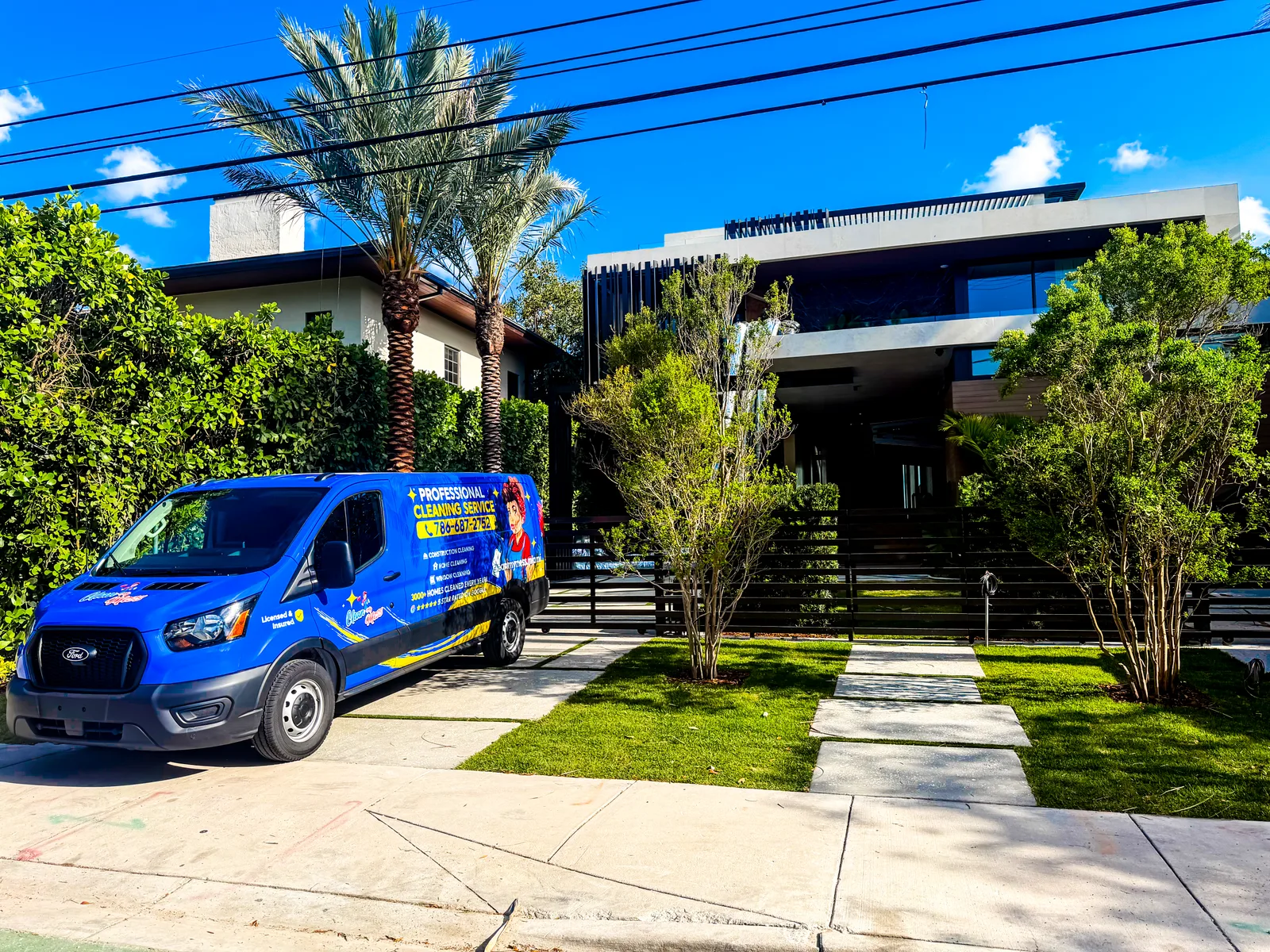 Clean My Mess branded van in front of a newly built Miami home ready for post-construction cleaning